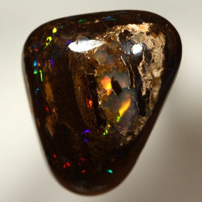 SOLID BOULDER OPAL High dome with very bright rolling flashes of red, orange, yellow, green, blue.